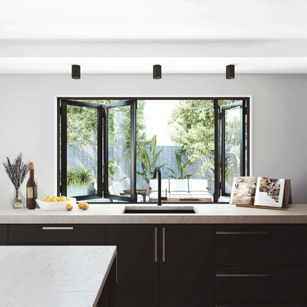 Stylish bifold windows opening to let natural light into a modern living room